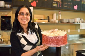 Alice Gonzalez, general manager of the Glebe location of Delightful Tastes, displays a red velvet cake. The store makes a variety of artful and custom cakes for weddings and special occasions. Photo: Ian Miller