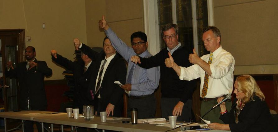 Mayoral candidates vote with their thumbs at the Capital Ward all-candidates’ meeting on October 2. From left: Bernard Couchman, Michael St. Arnaud, Robert White, Anwar Syed, Jim Watson, Mike Maguire.  Photo: LorrieLoewen