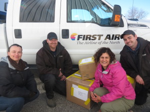 Anita Barewal (in pink), one of the founders of the Warm Hands Network, works with members of partner airline First Air to ship warm mittens and other hand-made knitted goods to northern Canada.